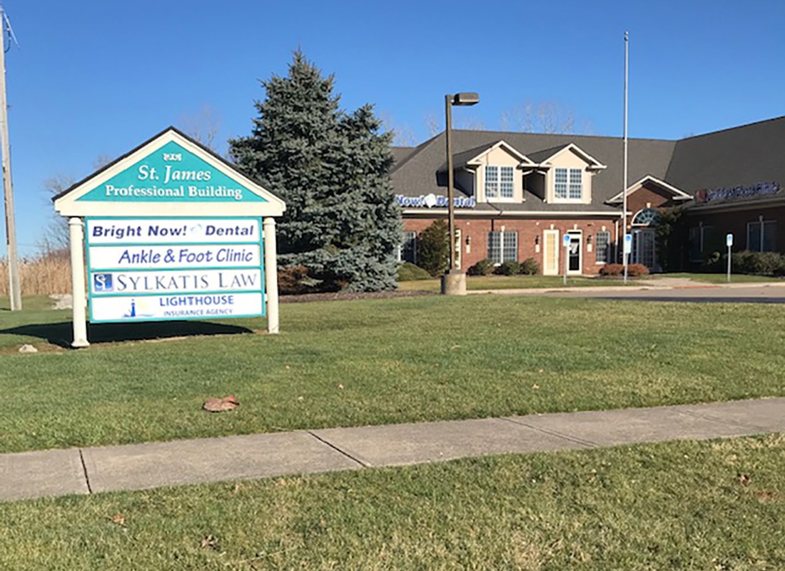 Contact - Exterior View of the Lighthouse Insurance Agency Office Building Against a Clear Blue Sky with Green Grass in the Front